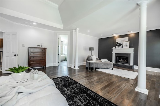 bedroom featuring lofted ceiling, ornamental molding, dark hardwood / wood-style flooring, and ornate columns