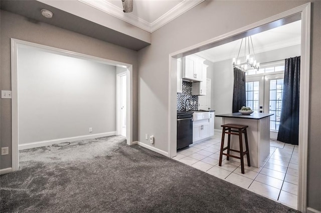 kitchen with a kitchen breakfast bar, light carpet, a kitchen island, and white cabinets