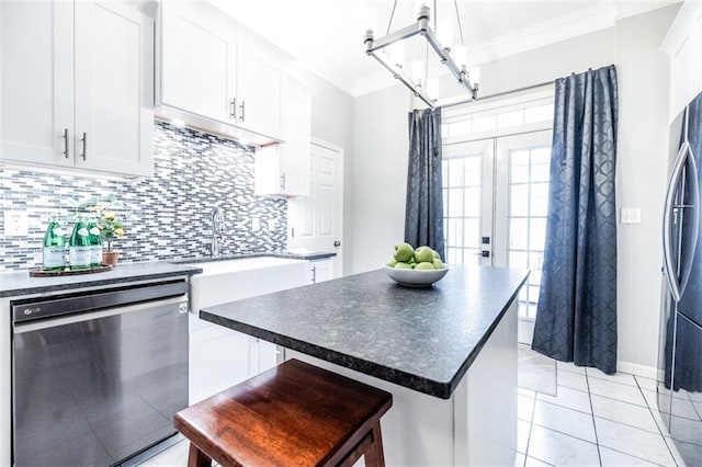 kitchen with white cabinetry, a kitchen island, black dishwasher, and tasteful backsplash