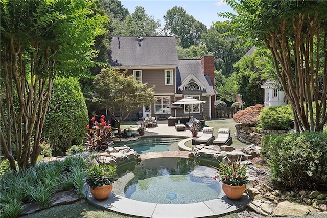 view of swimming pool with a patio area and an in ground hot tub