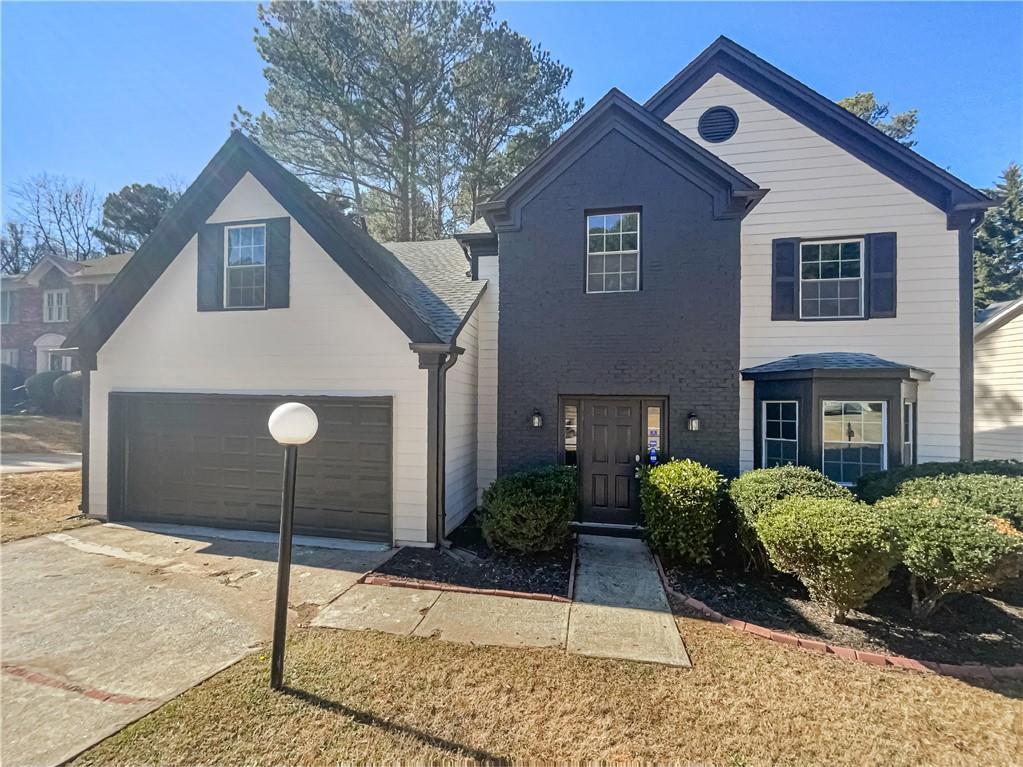 view of front property with a garage and a front yard