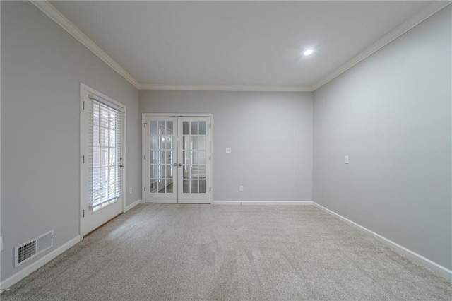 spare room with baseboards, visible vents, ornamental molding, and french doors