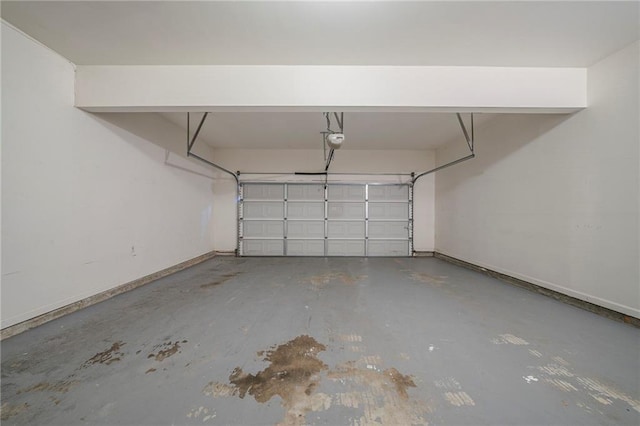 garage with a garage door opener and baseboards