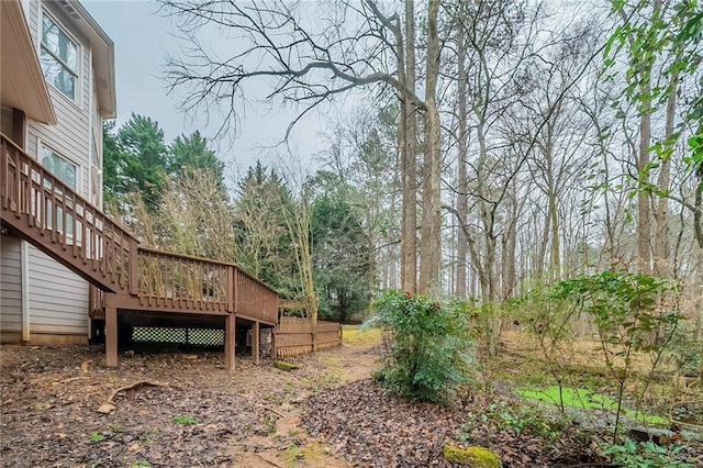 view of yard featuring stairway and a wooden deck