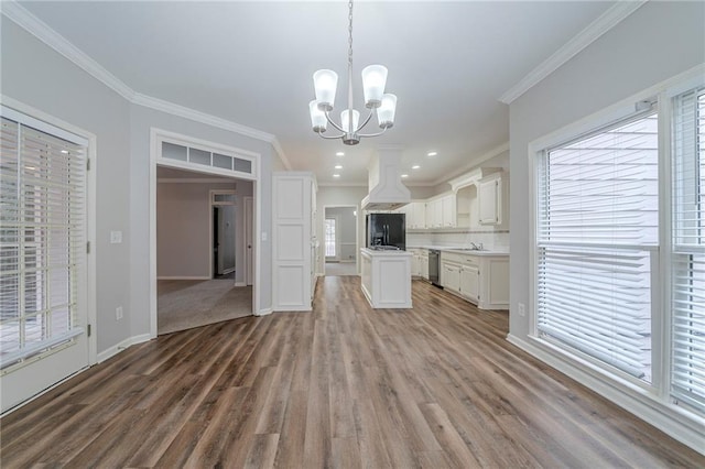 kitchen featuring dishwasher, custom exhaust hood, light countertops, white cabinetry, and pendant lighting