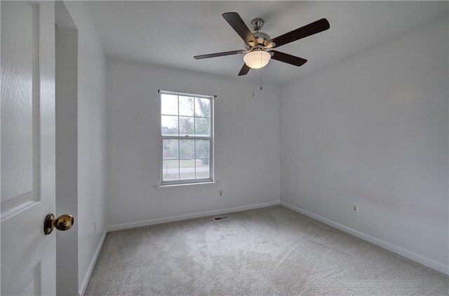 empty room with ceiling fan and carpet floors