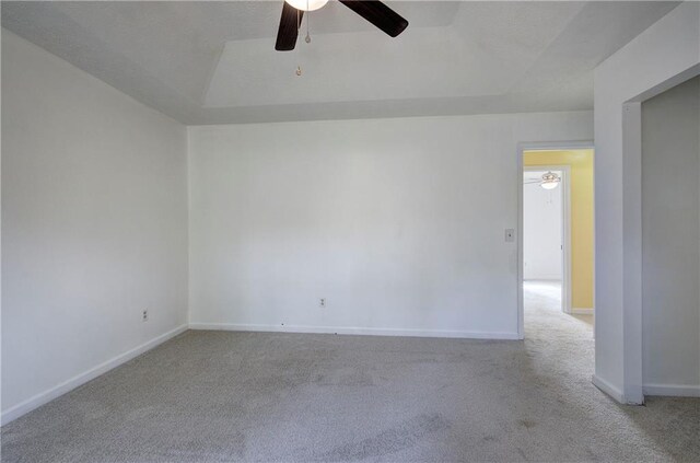 spare room with light colored carpet and ceiling fan