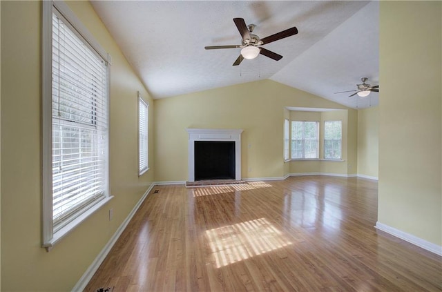 unfurnished living room with wood-type flooring, ceiling fan, and lofted ceiling