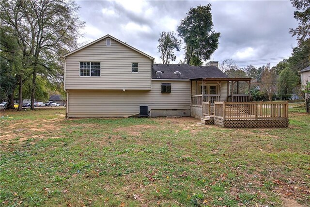 back of house featuring central AC unit, a yard, and a deck