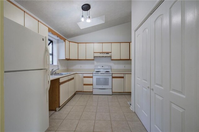 kitchen with light tile patterned floors, hanging light fixtures, sink, white appliances, and lofted ceiling