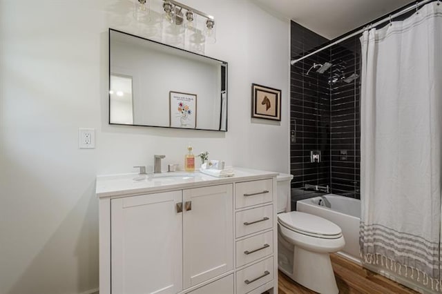 full bath with toilet, wood finished floors, vanity, and shower / bathtub combination with curtain