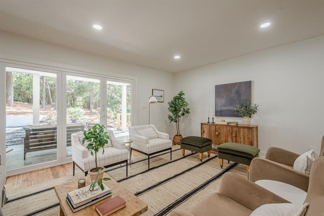 living area featuring light wood finished floors, plenty of natural light, and recessed lighting