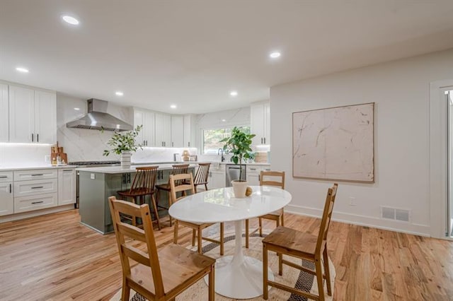 dining space featuring light wood-type flooring, visible vents, and recessed lighting