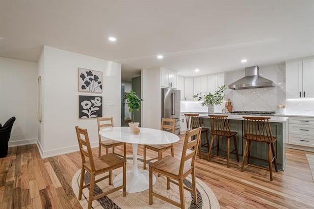 dining room featuring baseboards, recessed lighting, and light wood-type flooring