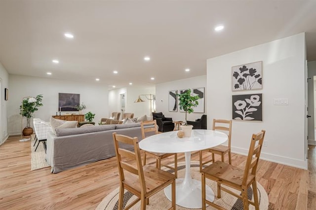dining space featuring baseboards, light wood-style floors, and recessed lighting