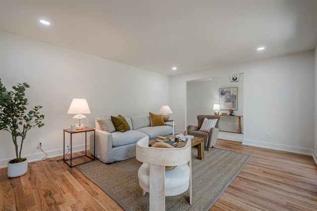 living area with light wood finished floors, baseboards, and recessed lighting