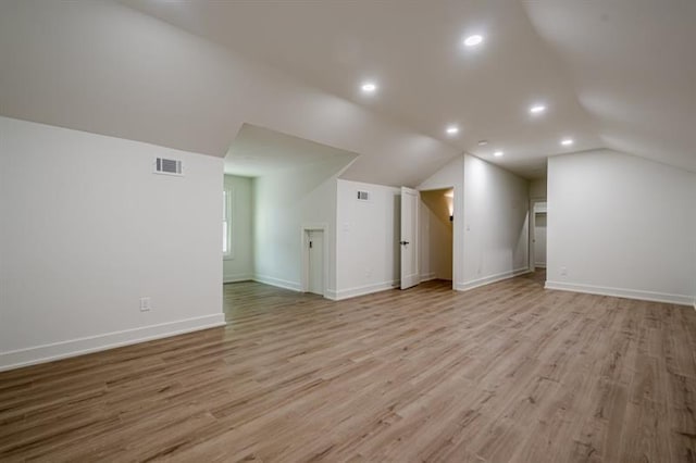 bonus room with lofted ceiling, recessed lighting, light wood finished floors, and visible vents