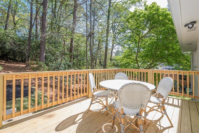 wooden terrace with outdoor dining area