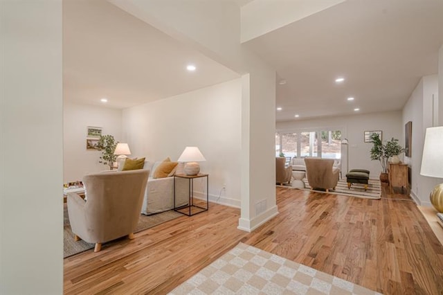 living room with recessed lighting, baseboards, and wood finished floors