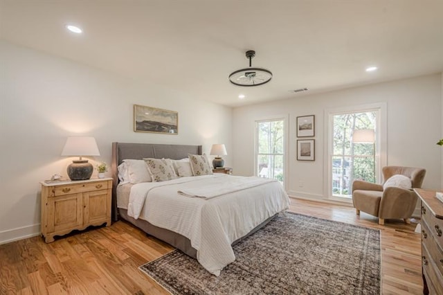 bedroom with recessed lighting, baseboards, visible vents, and light wood-style floors