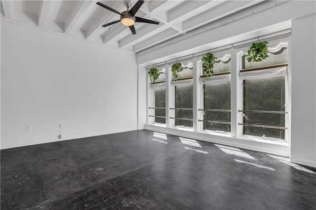 unfurnished room featuring beamed ceiling, concrete flooring, and ceiling fan