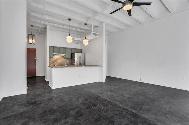 unfurnished living room featuring beamed ceiling and ceiling fan