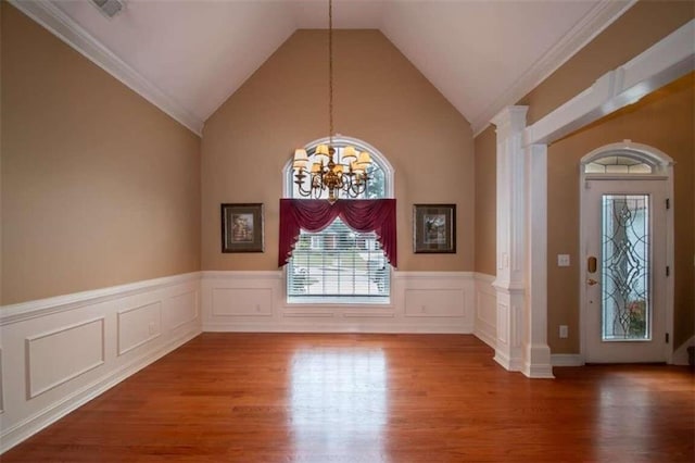 interior space featuring hardwood / wood-style floors, an inviting chandelier, and ornamental molding