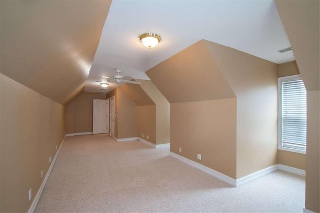 bonus room featuring ceiling fan, light colored carpet, and vaulted ceiling