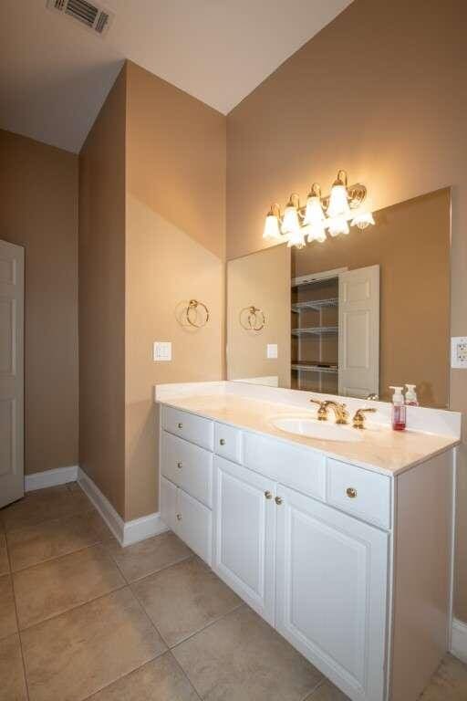 bathroom with tile patterned flooring and vanity