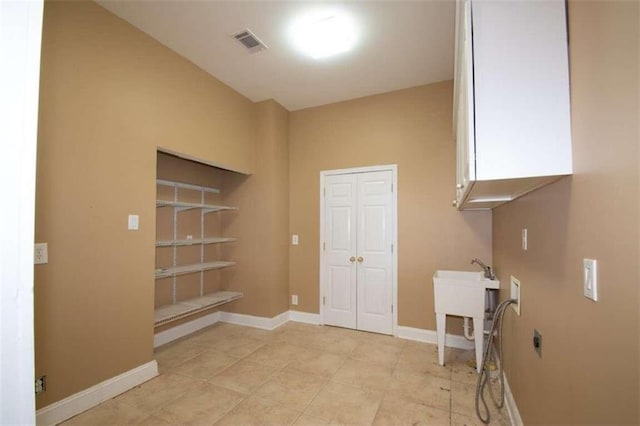 washroom featuring cabinets, hookup for a washing machine, electric dryer hookup, and light tile patterned flooring