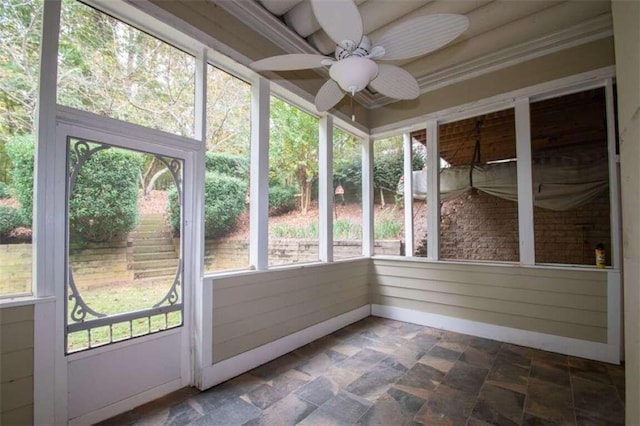 unfurnished sunroom with ceiling fan and a healthy amount of sunlight