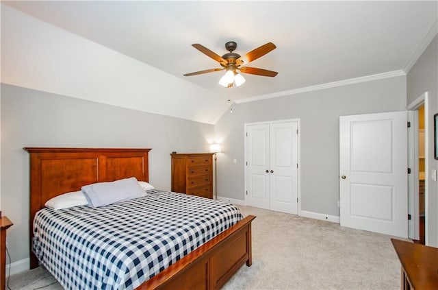 bedroom with a closet, ornamental molding, baseboards, and light carpet