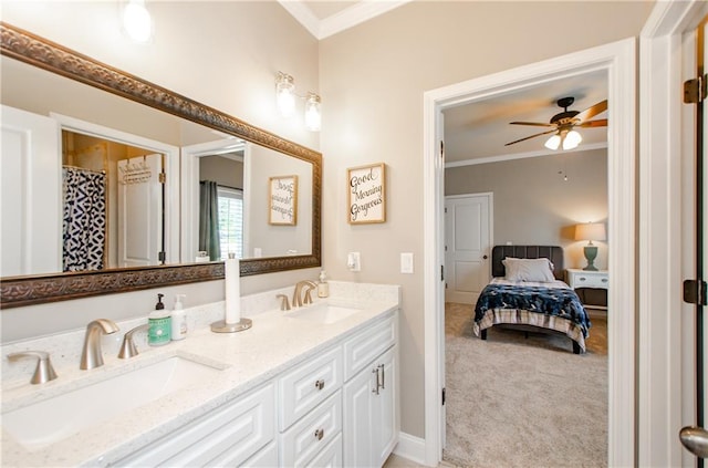 ensuite bathroom with a sink, ornamental molding, and a ceiling fan