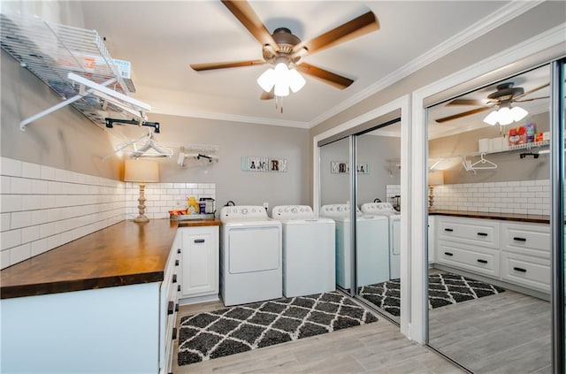laundry area with ceiling fan, cabinet space, ornamental molding, and independent washer and dryer