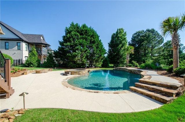 view of pool with a patio and a pool with connected hot tub