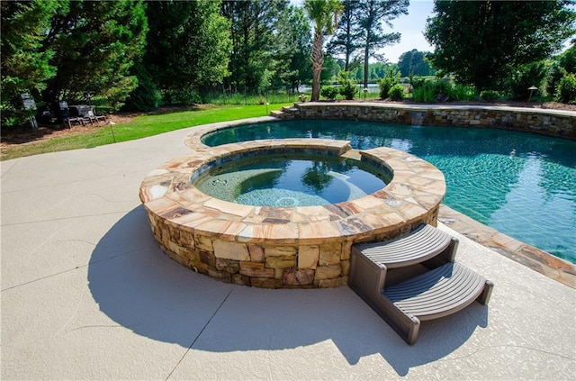 view of pool with a pool with connected hot tub