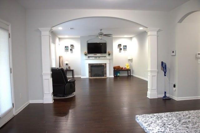 living room with ceiling fan and dark wood-type flooring