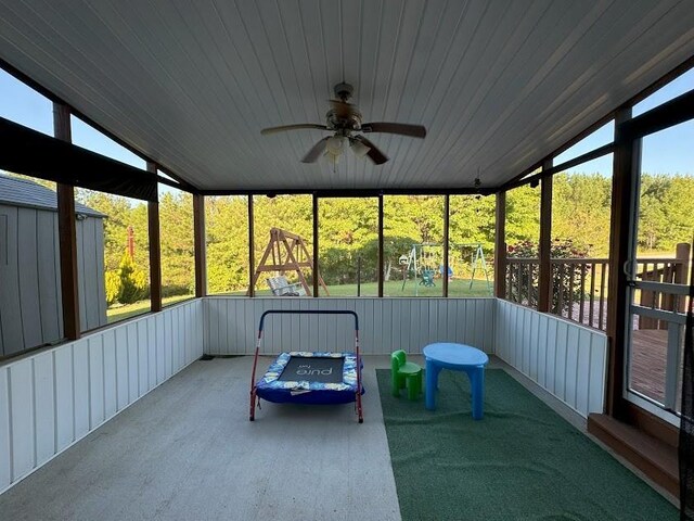 unfurnished sunroom with ceiling fan, wood ceiling, and lofted ceiling