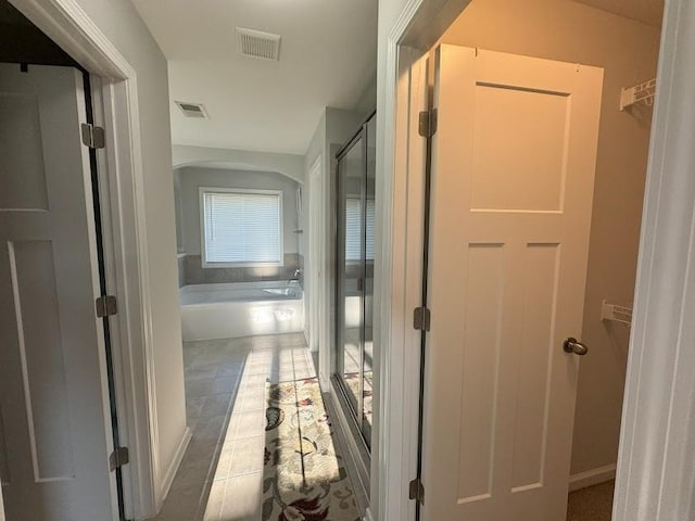 hallway with tile patterned floors