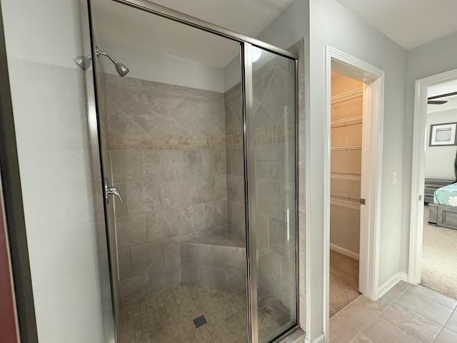 bathroom featuring tile patterned floors and a shower with door