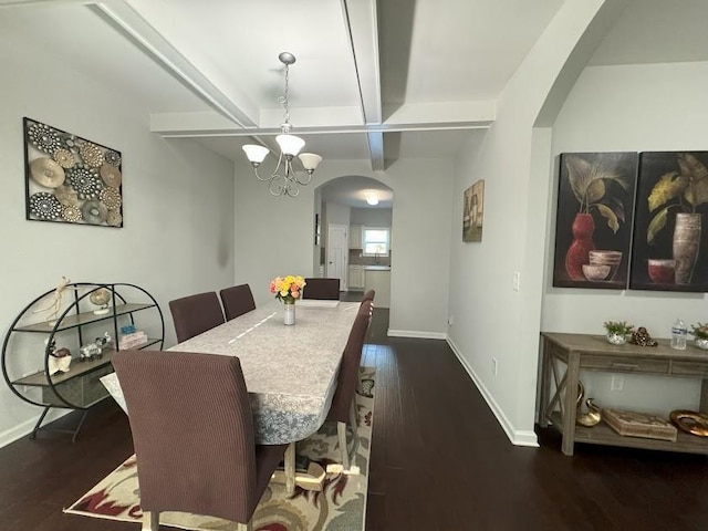 dining area featuring beam ceiling, coffered ceiling, a chandelier, and dark hardwood / wood-style floors