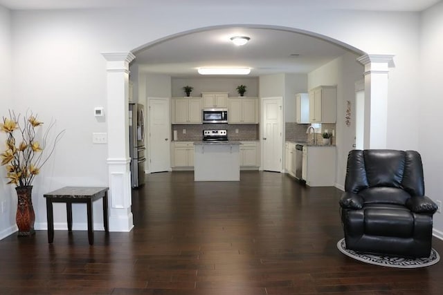 living room with dark hardwood / wood-style flooring and sink