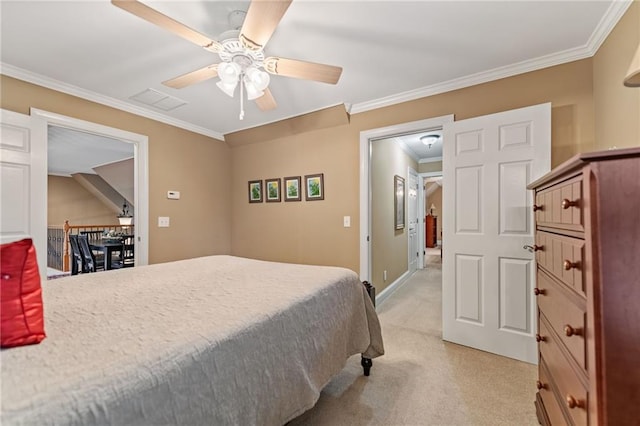 carpeted bedroom with ornamental molding and ceiling fan