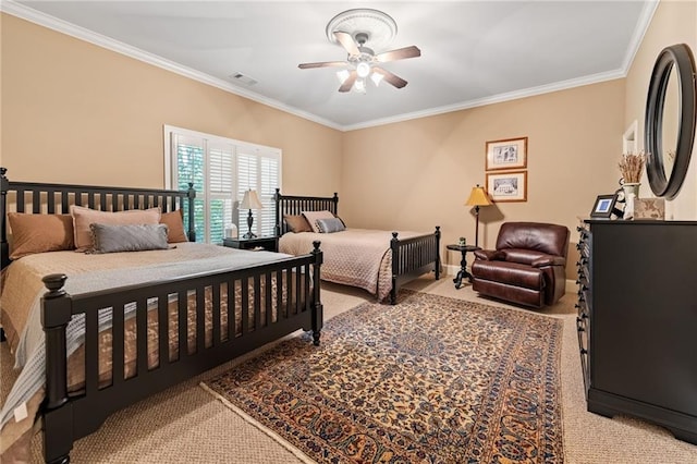 bedroom with ornamental molding, carpet, and ceiling fan