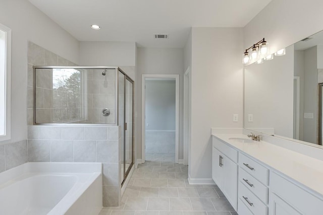 bathroom featuring tile patterned floors, vanity, separate shower and tub, and a wealth of natural light