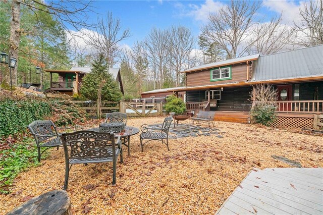 view of front facade featuring covered porch and a fire pit