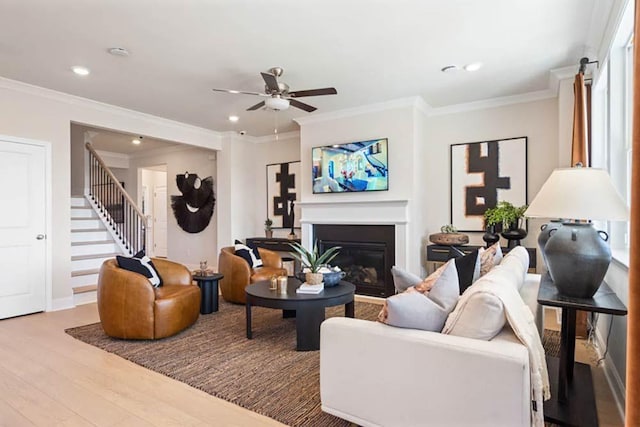 102 Sheryl Way, Loganville, GA 30052 - living room with wood finished floors, stairs, a glass covered fireplace, a ceiling fan, and recessed lighting