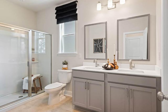 102 Sheryl Way, Loganville, GA 30052 - bathroom featuring toilet, double vanity, and a stall shower