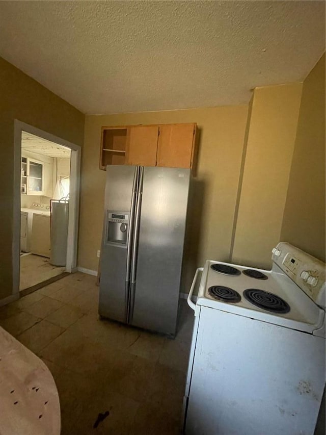 kitchen with light brown cabinets, white electric stove, a textured ceiling, and stainless steel refrigerator with ice dispenser