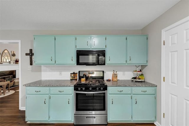 1050 Birdseye Vw, Locust Grove, GA 30248 - kitchen featuring black microwave, gas range, decorative backsplash, blue cabinets, and dark wood finished floors